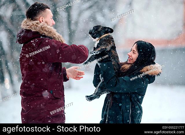 Beautiful young couple having fun in the snowy city