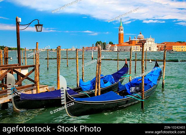 Gondolas moored near San Marco square across from San Giorgio Maggiore island in Venice, Italy. Gondolas were once the main form of transportation around the...