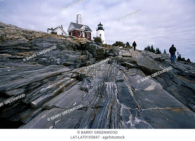 Lighthouse. Rocky shore, headland. Rock formations, striations