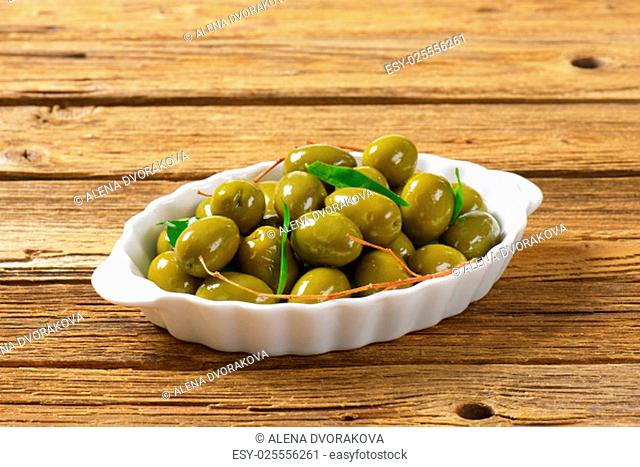 Fresh green olives in ceramic dish