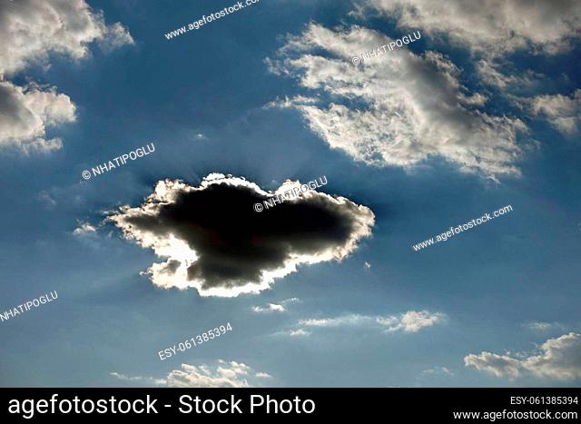 black cloud forming in the blue sky, dark cloud forming in different and interesting shapes