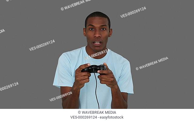 Casual young man playing video games