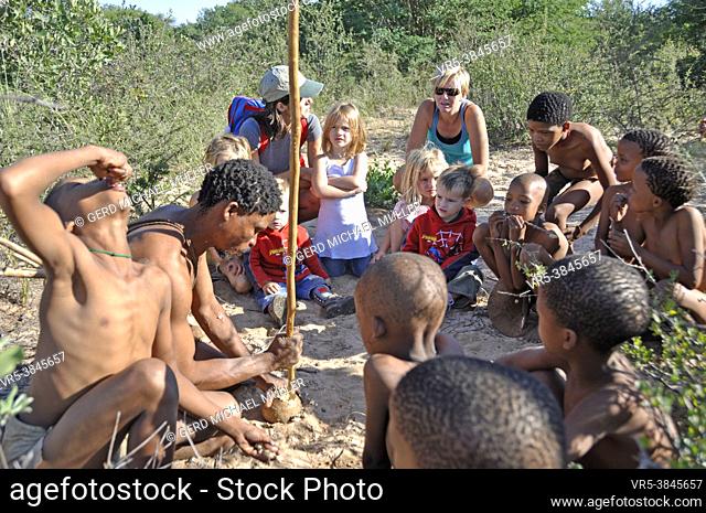 Botswana: A group of bushmen hunter in the Central Kalahari near Ghanzi with local south african family