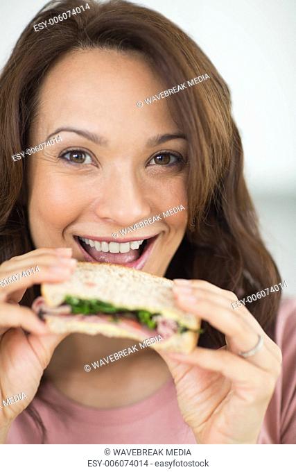 Closeup portrait of a woman eating sandwich