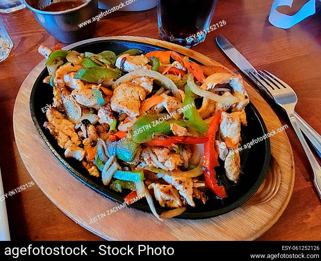chicken meat and bell peppers and onion fajita on plate
