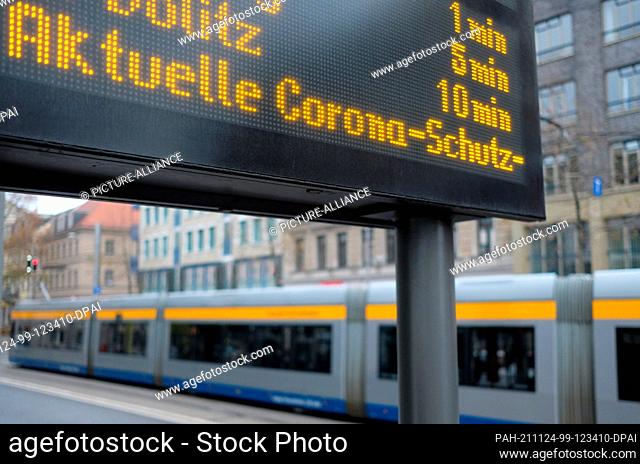 24 November 2021, Saxony, Leipzig: The display board of a tram stop shows information about the Corona protection regulation. As of Nov