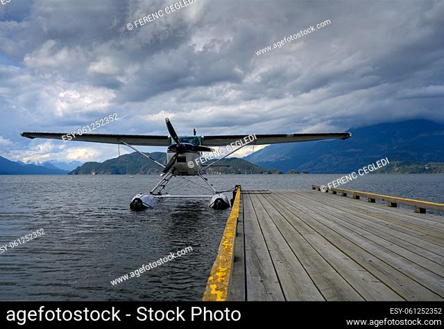 Hydroplane tied to the water aerodrome on Harrison Lake over blue and cloudy sky in Harrison Hot Springs, British Columbia, Canada