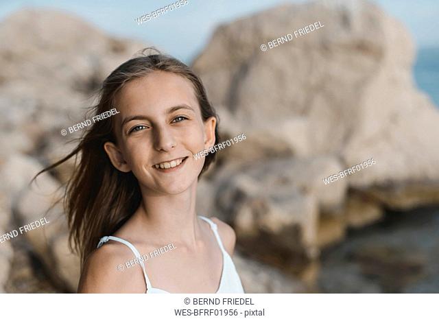Croatia, Lokva Rogoznica, portrait of smiling girl on the beach