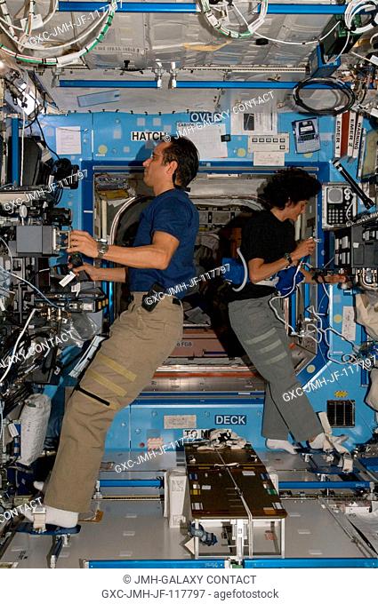 NASA astronauts Joe Acaba and Sunita Williams, both Expedition 32 flight engineers, work in the Destiny laboratory of the International Space Station
