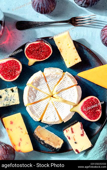 Cheese selection, elegant assortment, shot from above on a blue background