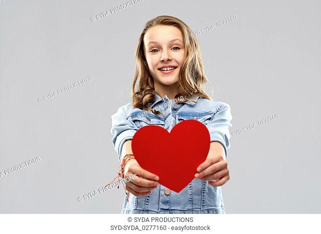smiling teenage girl with red heart