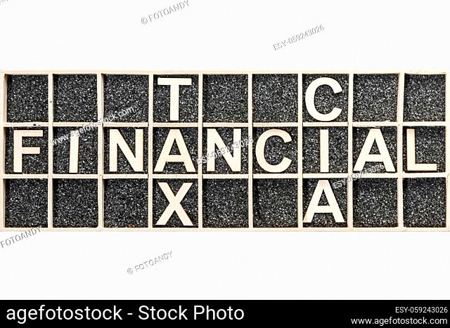 With plywood letters on black decor sand representing the crossing words FINANCIAL, TAX and CIAim wooden collection box in top view on white background
