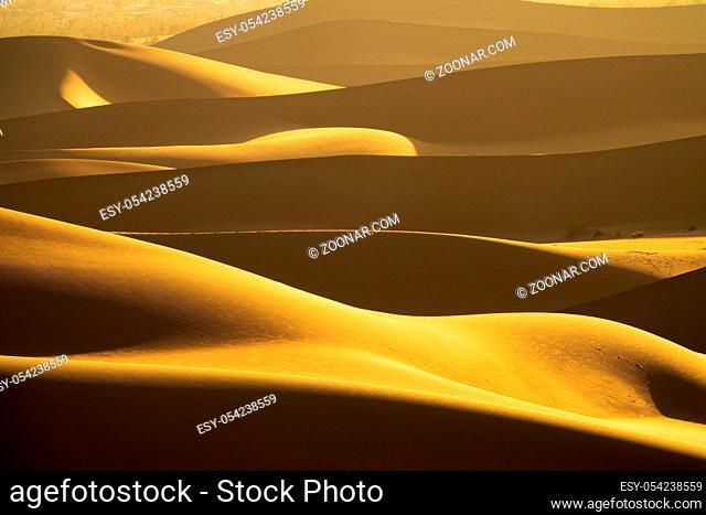 Background with beautiful structures of sandy dunes in the Sahara desert