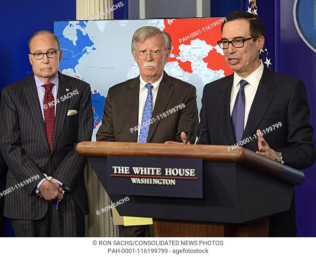 United States Secretary of the Treasury Steven T. Mnunchin, right, conducts a briefing with National Security Advisor John R
