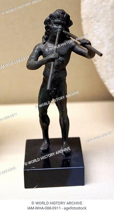 Bronze figure of a satyr playing double-pipes. Dated 1st Century