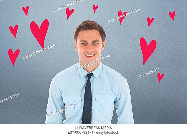 Composite image of happy businessman standing with hands in pockets