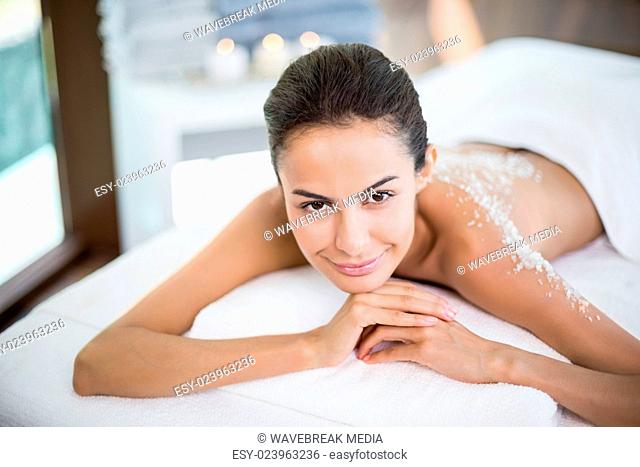 Beautiful woman relaxing on massage table at spa