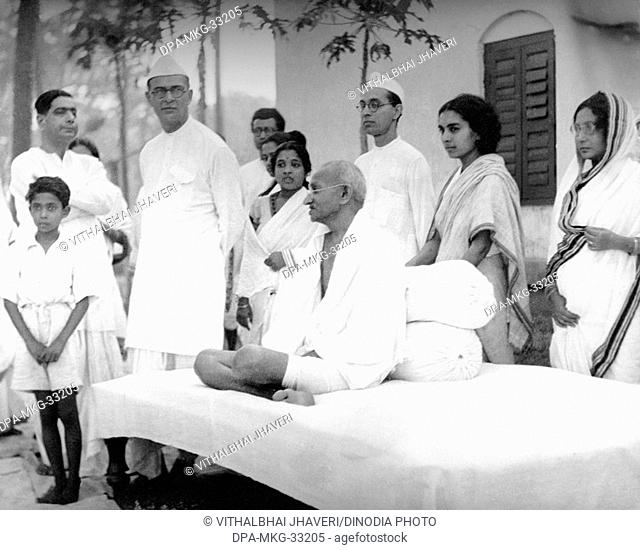 Mahatma Gandhi with his co-workers Dr. Sushila Nayar (second  right), her brother Pyarelal Nayer (next to her) and Mahadev Desai (third left) at Sodepur Ashram
