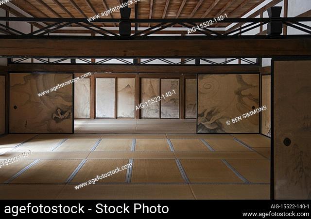 An interior view with natural light shows the tatami mat rooms with hand-painted fusuma sliding doors and natural wood ceiling in the Kuri main hall at Ryoan-ji