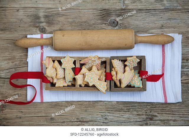 Gingerbread biscuits in wooden boxes with a rolling pin