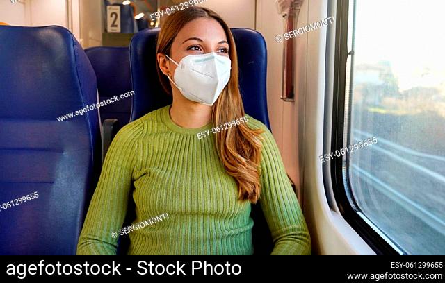 Portrait of woman traveling on public transport wearing protective medical mask. Banner cropped photo of girl with face mask enjoying view through the window on...