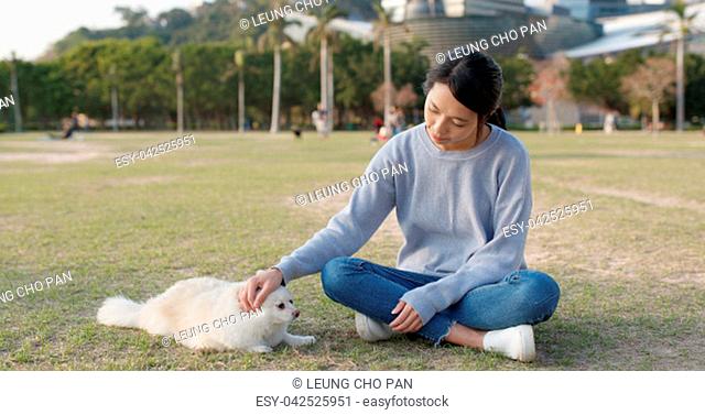 Woman playing with her dog at outdoor park