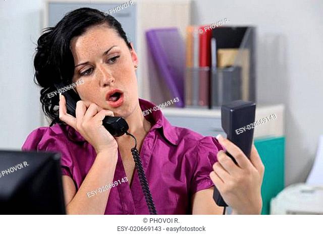 Annoyed receptionist answering ringing phones