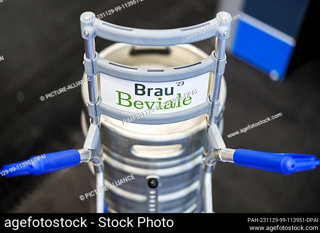 28 November 2023, Bavaria, Nuremberg: ""Brau Beviale"" is written on the sign of a sack truck at the BrauBeviale beverage trade fair on the stand of the German...