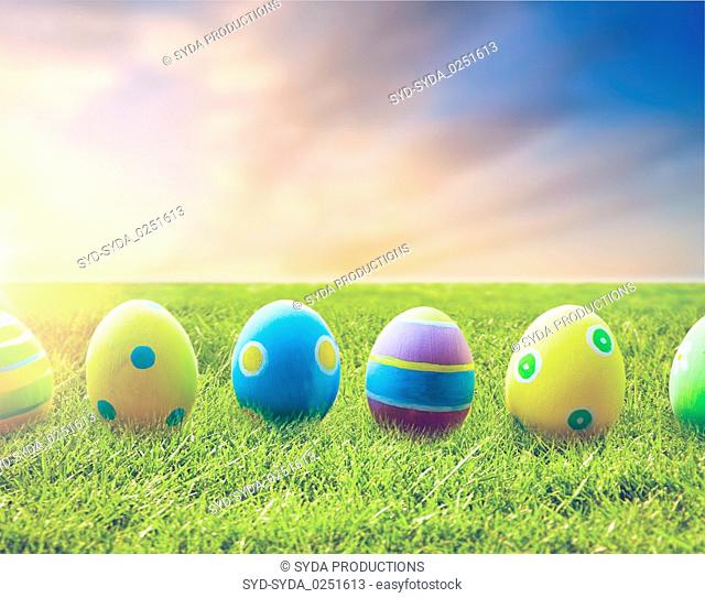 close up of colored easter eggs on grass