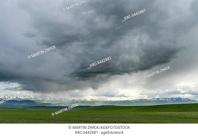 Thunderstorm over the Suusamyr plain, a high valley in Tien Shan Mountains. Asia, central Asia, Kyrgyzstan