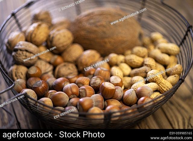 different kinds of nuts on a wooden background