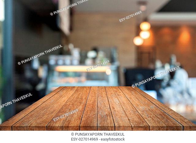 Perspective top wooden with blurred coffee shop. product display template