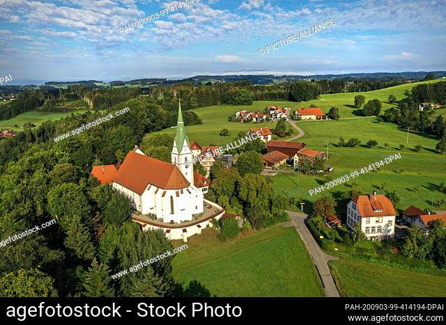 03 September 2020, Baden-Wuerttemberg, Amtzell: The pilgrimage church of the Nativity of the Virgin Mary is situated on a wooded mountain range above the river...
