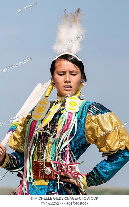 Female dancer in jingle dance regalia, Pow-wow, Blackfoot Crossing Historical Park, Alberta, Canada