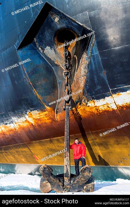 Portrait of man posing on top of anchor of ice-breaker 50 Years of Victory