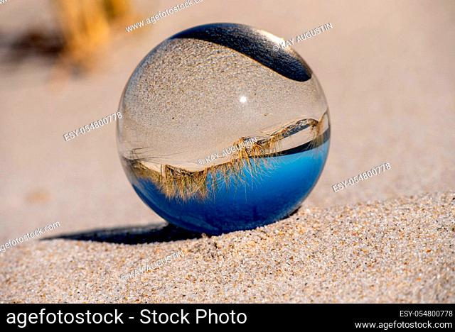 Artistic glass ball photography on the North Sea beach