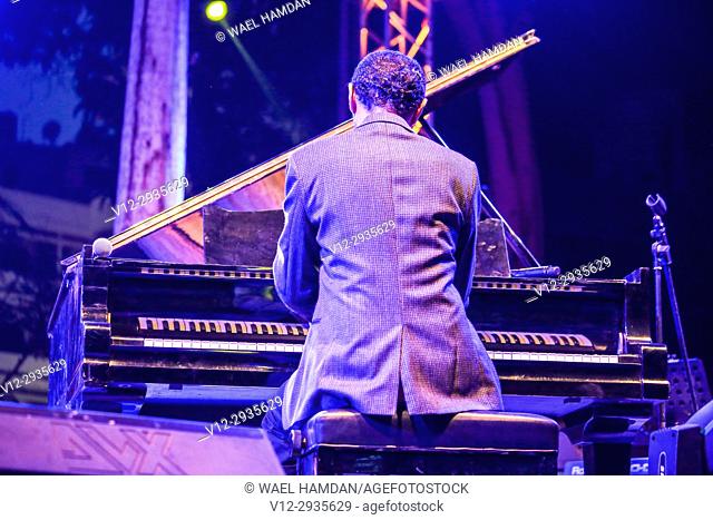 Musician playing piano on stage