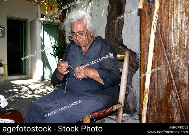 An old woman crochets tablecloths that she sells to tourists in the village of Omodos. Cyprus