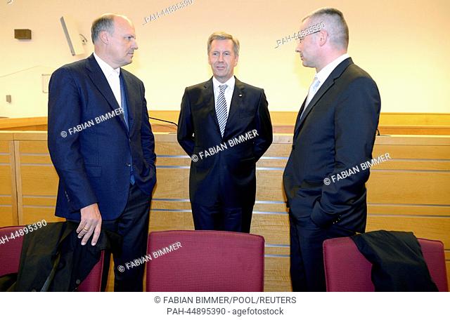 Former German President Christian Wulff (C) and his lawyers Michael Nagel (L) and Bernd Muessig (R) stand at the regional court in Hanover, December 19, 2013