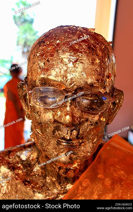 Golden head of monk in buddhist temple in Prachuap Khiri Khan, Thailand