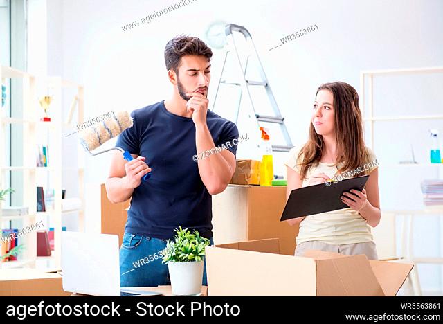 Young family unpacking at new house with boxes