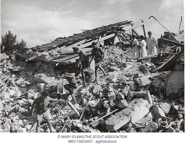 Scouts in the ruins of Argostolion, Kefalonia, Greece. Four earthquakes hit the island in August 1953, destroying many buildings; the scouts helped with...