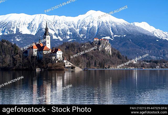 15 February 2021, Slovenia, Bled: The Church of the Assumption of the Virgin Mary on the island of Blejski Otok in Lake Bled at the foot of the Pokljuka plateau