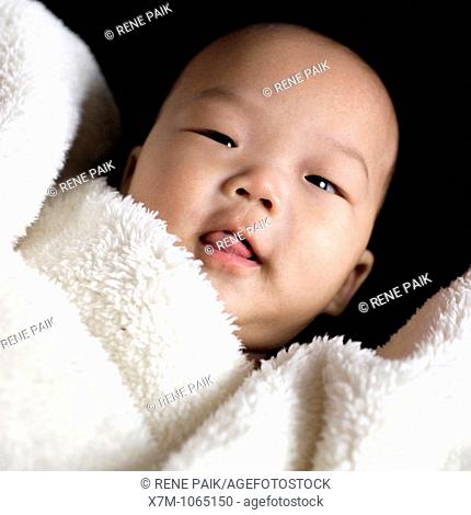 Asian baby boy covered by blanket