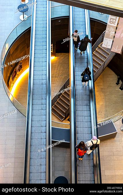 Copenhagen, Denmark People riding escalators inside the Black Diamond Royal Library