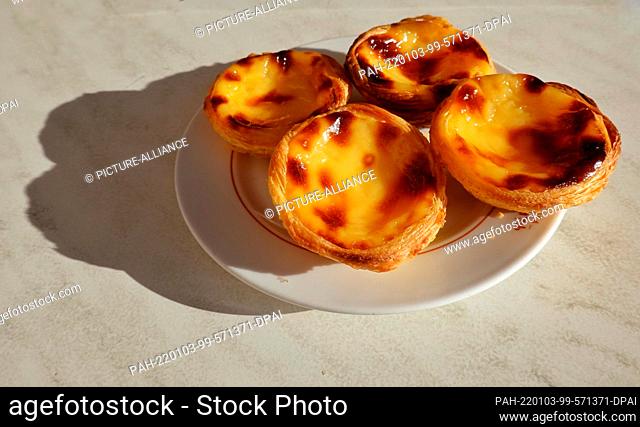 01 January 2022, Portugal, Lissabon: Four custard tarts, Pasteis de Nata, lie on a plate in a café. Photo: Soeren Stache/dpa-Zentralbild/dpa