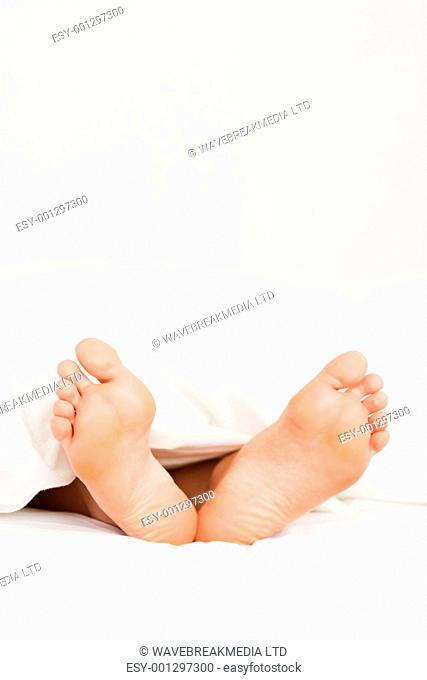 Close up of feet in a bed