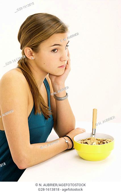 Teenage girl refusing to eat her cereals suffering from anorexia