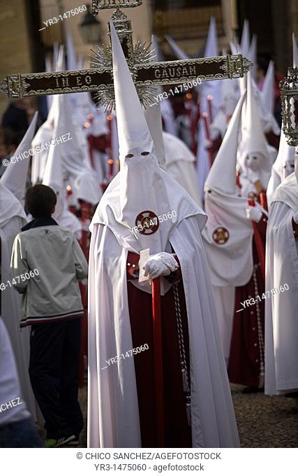 Penitents walk in the Orange Trees Court, Patio de los Naranjos in Spanish, in the Mosque-Cathedral of Cordoba during Easter Holy Week celebrations in Cordoba