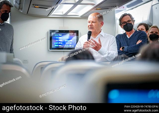 27 April 2022, Japan, Tokio: German Chancellor Olaf Scholz (SPD) speaks in a background interview with journalists traveling with him on the Air Force Airbus...